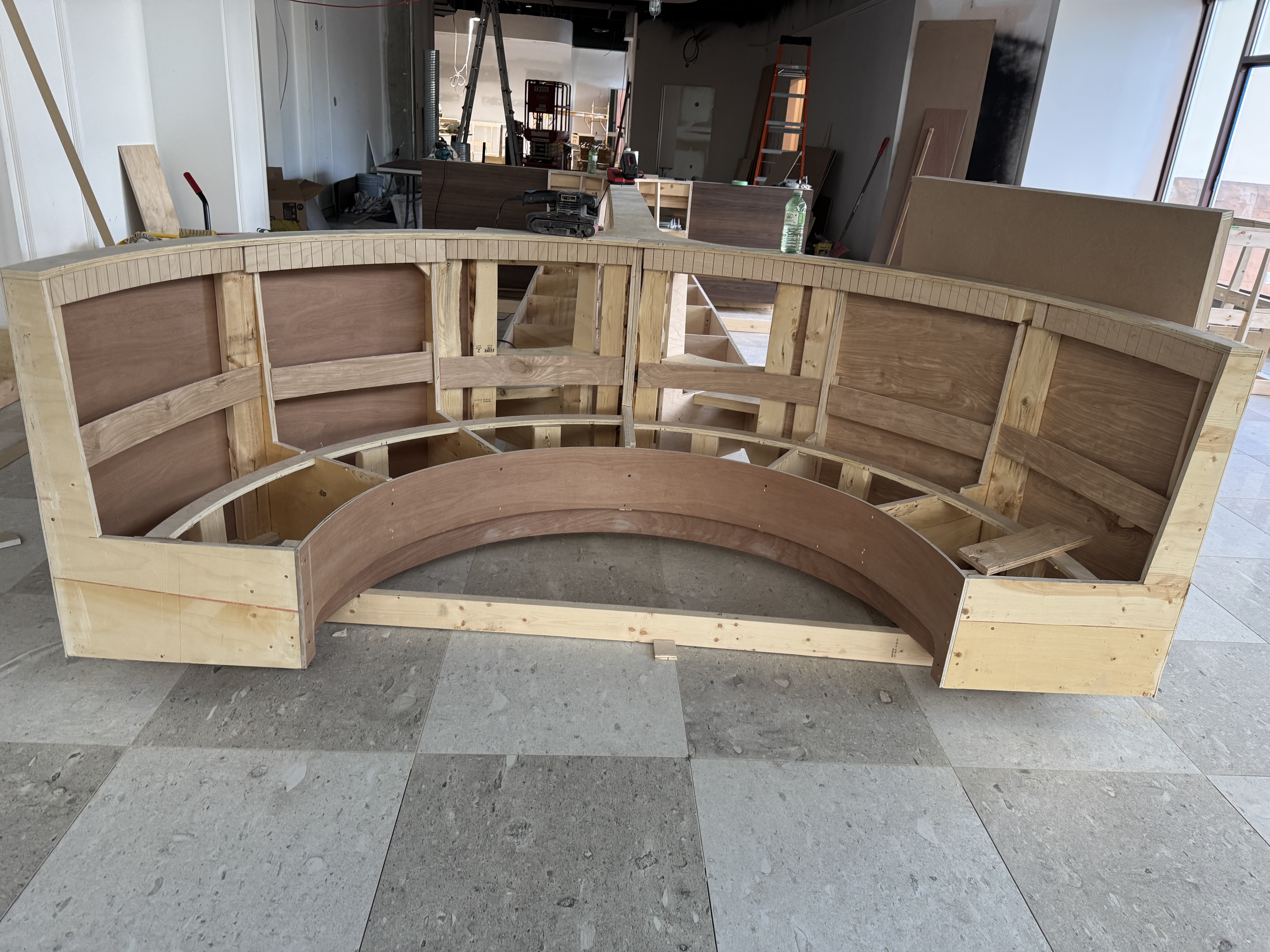 Curved booth frame under construction